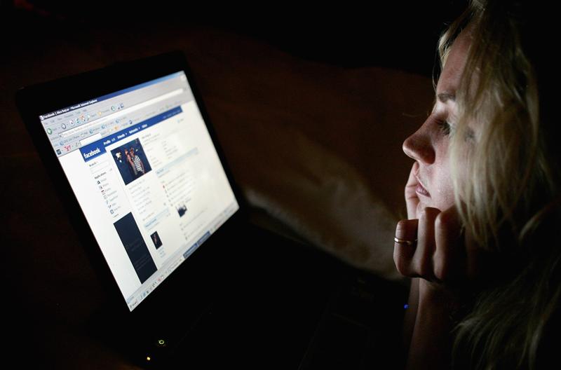 a_girl_in_london_looks_at_a_page_on_facebook_studi_7114602314